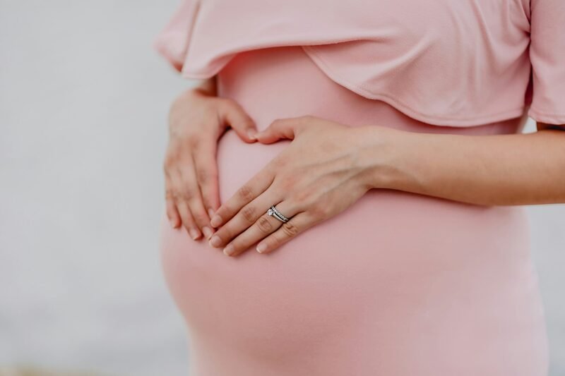 Image of a pregnant mom with her hands on her belly